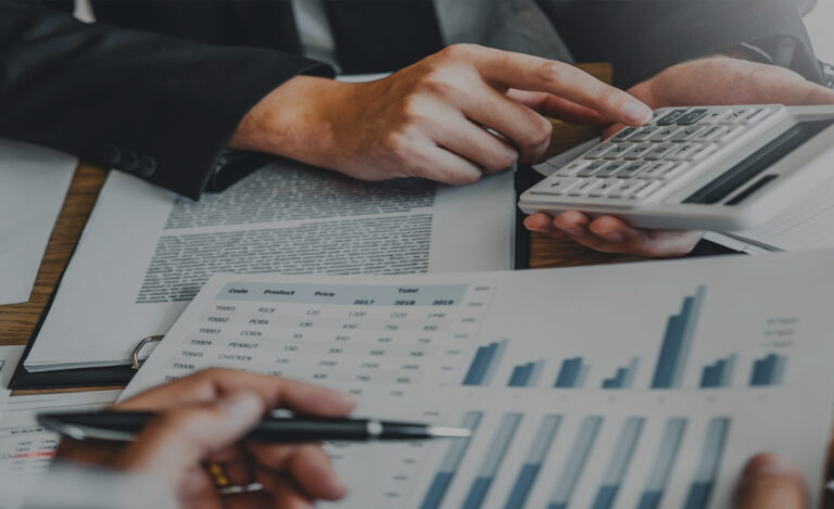 A desk with a neatly organized notebook, pen, and calculator, symbolizing budgeting and planning activities.