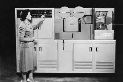 woman in front of a computer that fills the room, ready to upgrade erp
